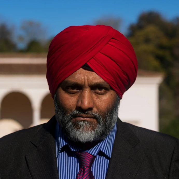 man in black suit jacket and red knit cap